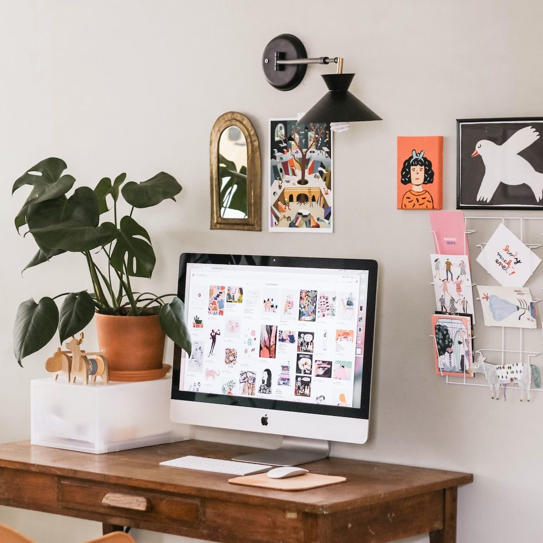 silver iMac on wooden desk